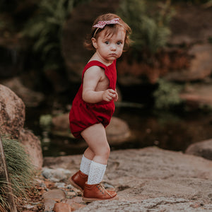 Side view of the Mackenzie corduroy unisex Christmas romper.