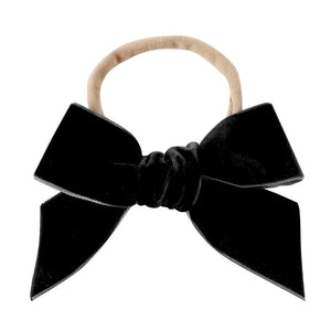 Black velvet hair bow attached to a nylon head band