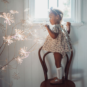Side view of Primrose Lavender floral smock for toddlers