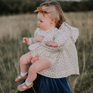 The Amelia blouse twinning with our matching Arabella baby romper in the same Bluebelle floral.