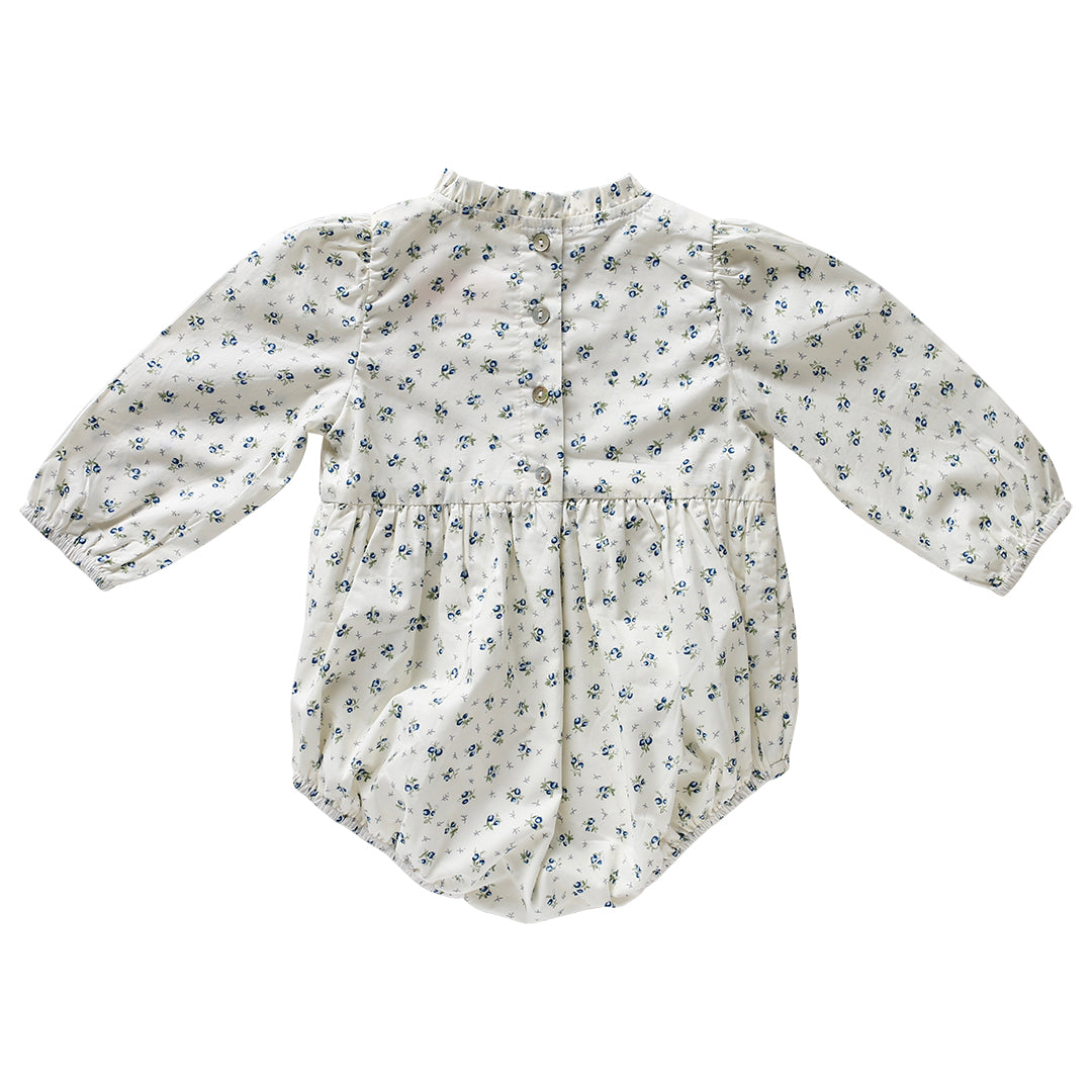 Back view of Arabella Bluebelle floral playsuit with shell button opebing