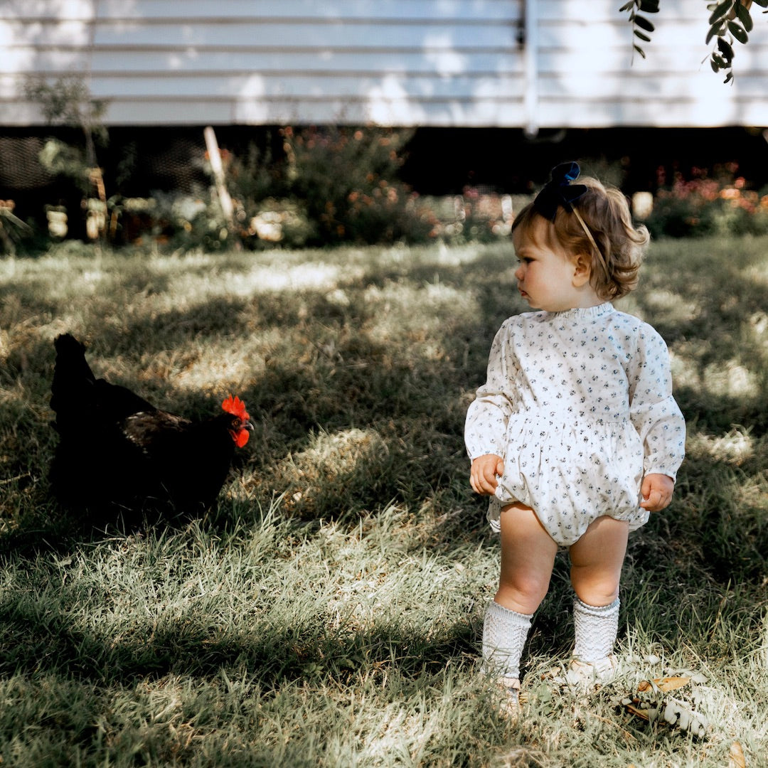 Front view of Arabella long sleeve baby girls playsuit