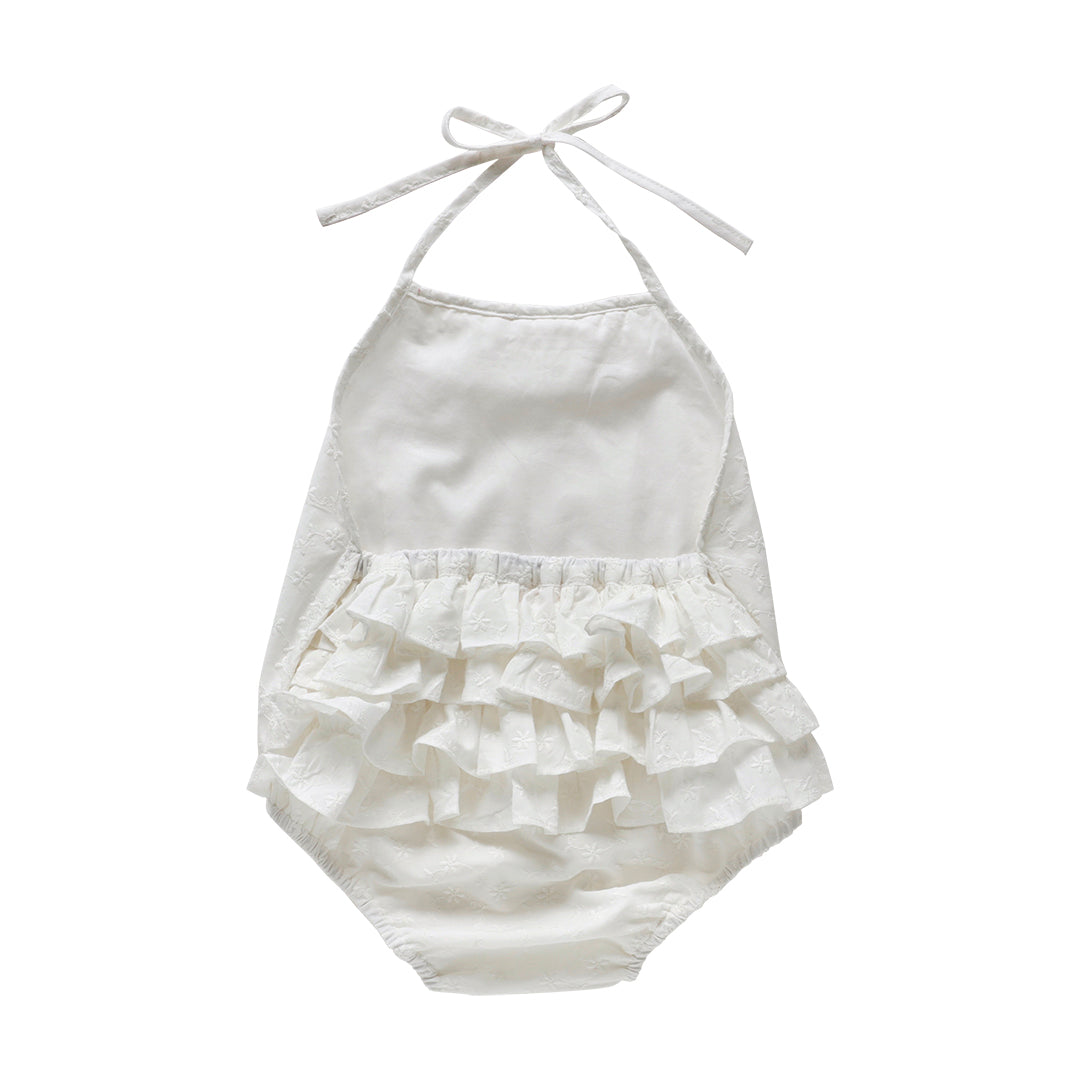 Back view of ivory halter tie ruffle romper