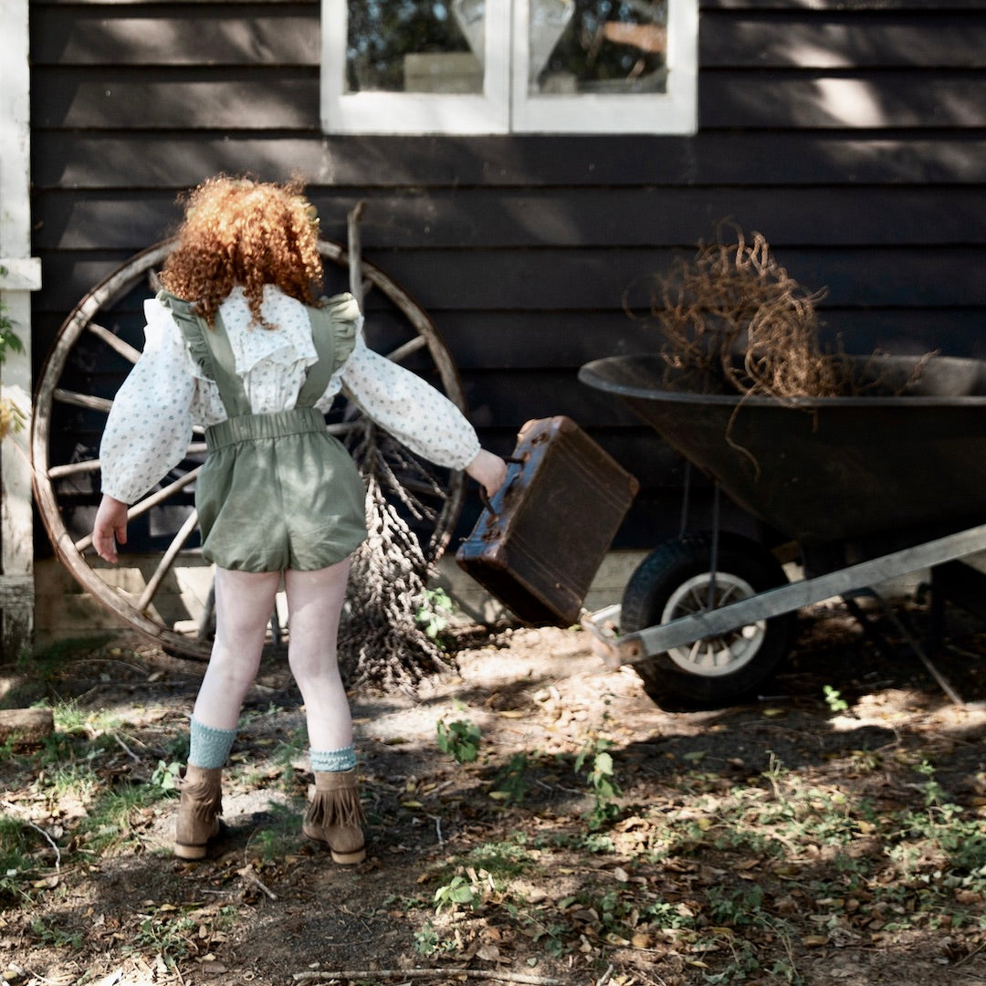 Back view of the Puck Playsuit styled with Amelia floral blouse