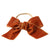 Terracotta velvet bow worn around hair bun